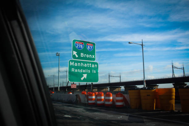 Signs on the Brooklyn-Queens Expressway Signs for The Bronx and Manhattan. Seen from the interior of a passing car. BQE stock pictures, royalty-free photos & images