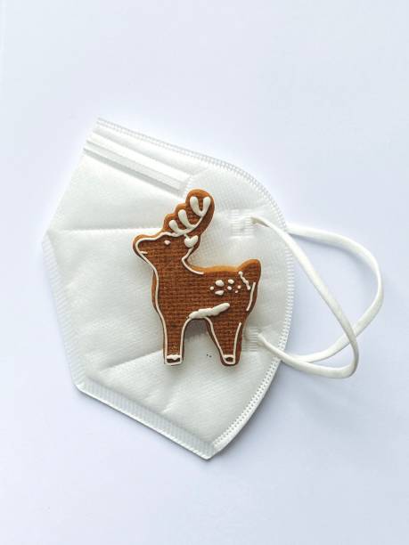 istock Funny Christmas lockdown wallpaper with deers in a face protective mask 1291460056