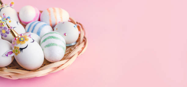 istock Unicorn eggs in the box isolated on pink background. Happy easter. Kids activity. 1291460503
