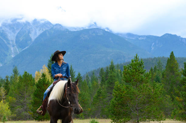 istock Woman riding her horse at a ranch 1291460747