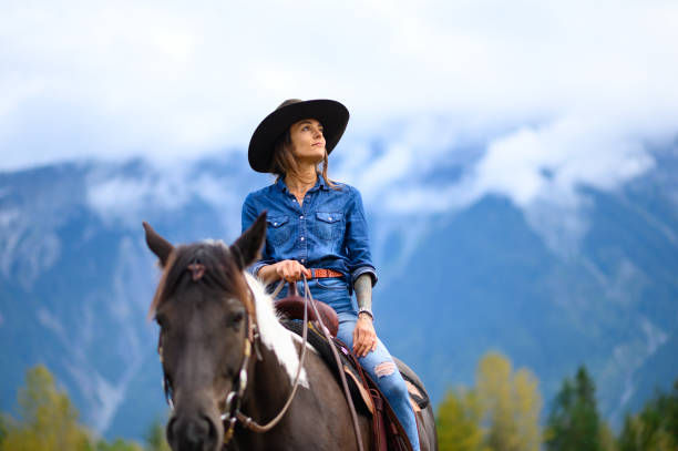 istock Woman riding her horse at a ranch 1291460811