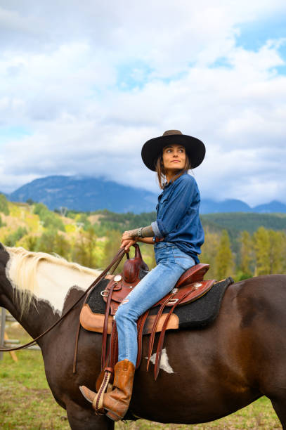istock Woman riding her horse at a ranch 1291460865