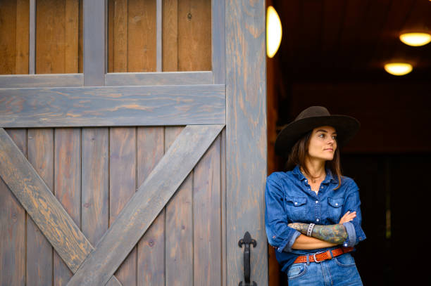 istock Modern cowgirl at the ranch 1291460876