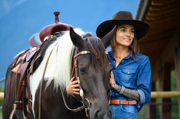 istock Female rancher working with her horse 1291460906