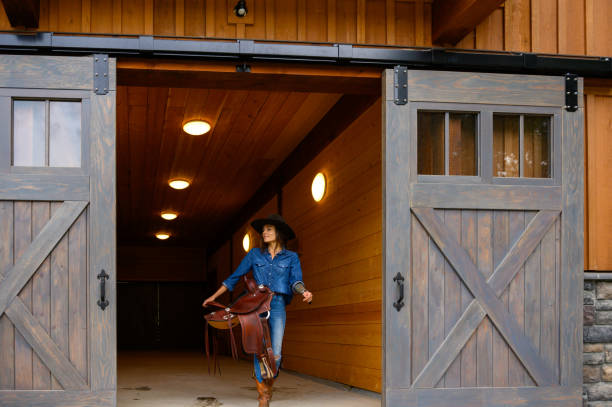 istock Female rancher in a tacking room 1291461050