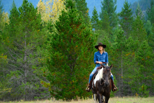 istock Woman riding her horse at a ranch 1291461072