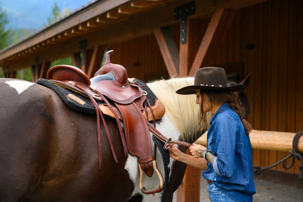 istock Female rancher working with her horse 1291461074
