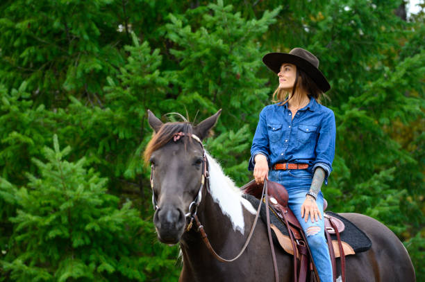 istock Woman riding her horse at a ranch 1291461079