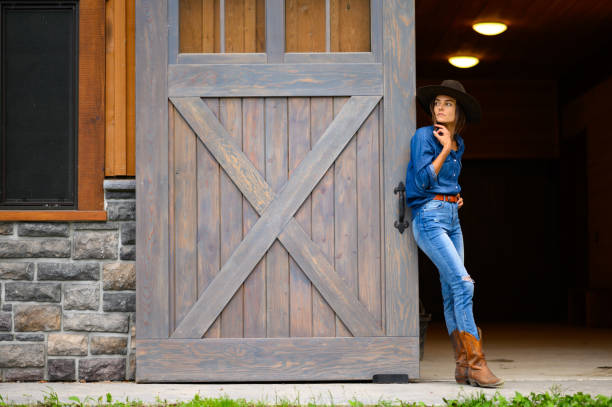 istock Modern cowgirl at the ranch 1291461125