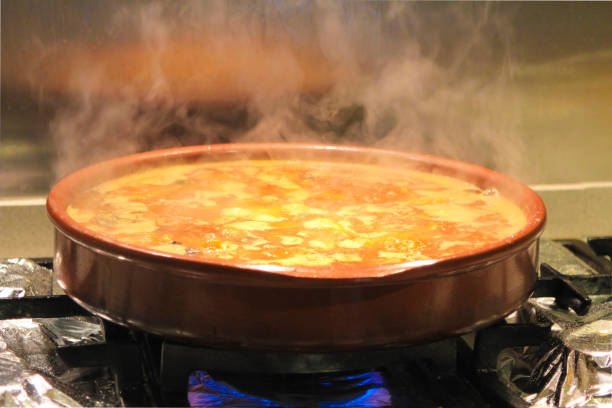 boiling broth with meat and sausages in a clay pot - main course imagens e fotografias de stock