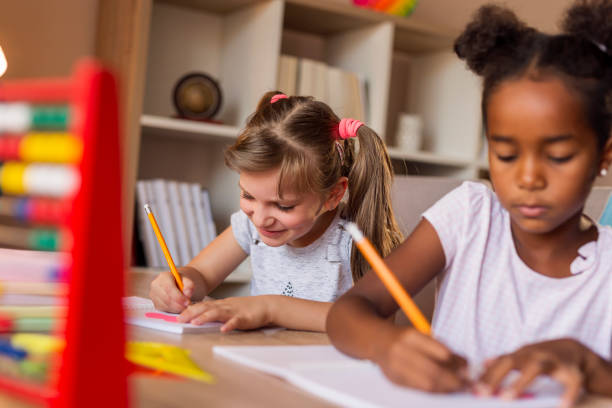 istock Little girls studying math at home 1291464563