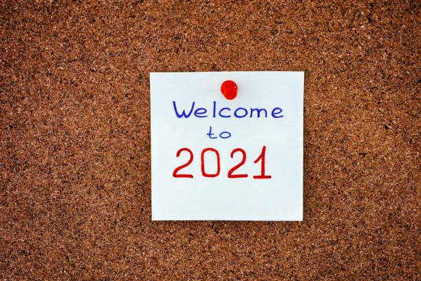 istock Paper note with phrase Welcome to 2021 on corkboard. 1291466442