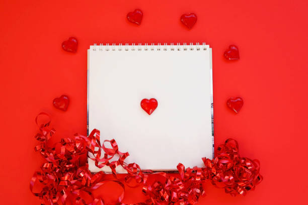 istock Notepad, souvenir heart isolated on red background. Party decoration, celebration, carnival for Valentine's day. 1291467621