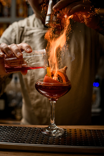 Barman Add Ingredients To Glass With Pumpkin And Pepper Inside And Makes  Fire Over It Stock Photo - Download Image Now - iStock