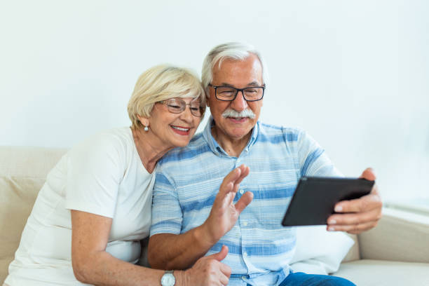 istock Senior couple using digital tablet at home. Grandparents using social media. Elderly couple together at home retirement concept using digital tablet 1291470588