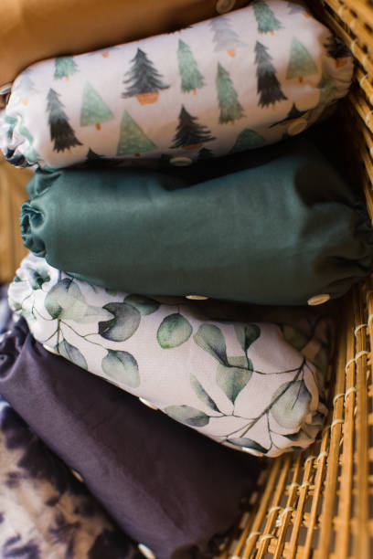 istock Modern Neutral-Colored Reusable Cloth Diapers with Sage-Green Christmas Trees & Eucalyptus Leaves Prints 1291472487
