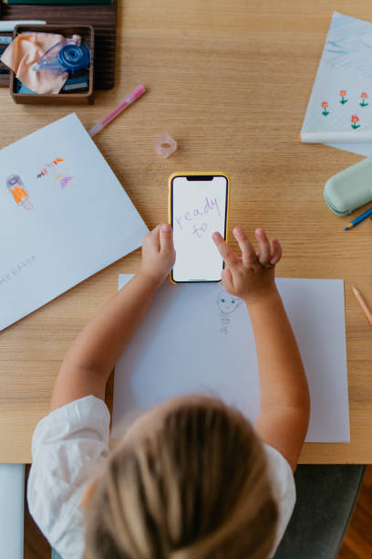 istock Anonymous Girl Drawing and Using her Smartphone for Inspiration 1291476313