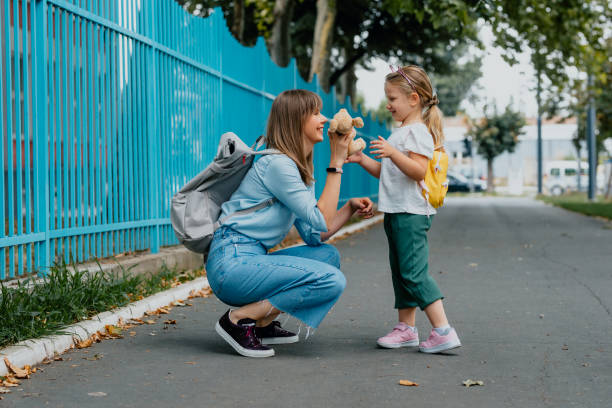 istock Mother Picking up her Daughter after School 1291476457