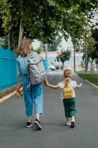 istock Anonymous Mother Taking her Daughter to School 1291476462