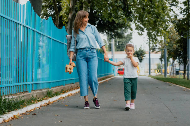 Mother Taking her Daughter to School