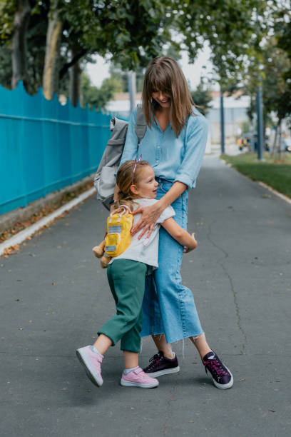 istock Mother Dropping her Daughter off to School 1291476471