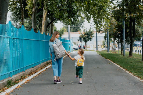 istock Unrecognizable Mother Taking her Daughter to School 1291476473