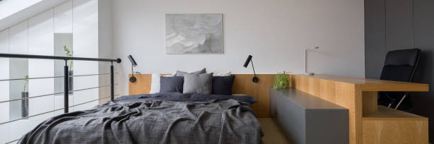 istock Modern bedroom with desk, panorama 1291487150