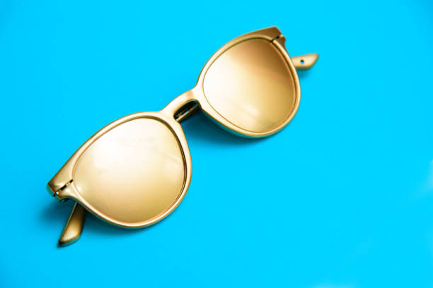 istock Golden eye glasses on a blue background 1291487542