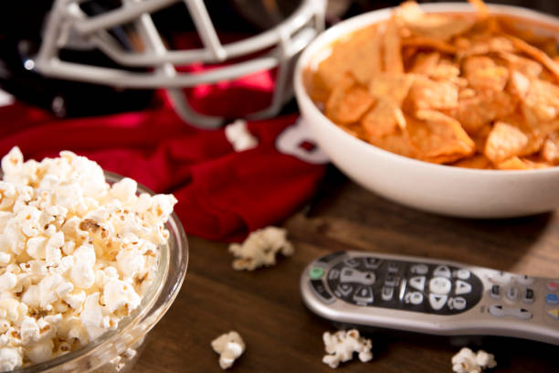 istock Watching the football game with snacks, drinks. 1291488113