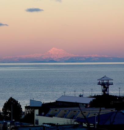 Looking at Mt. Baker from Port Angeles Washington across the Strait of Juan de Fuca on a cold frozen day near sunset time
