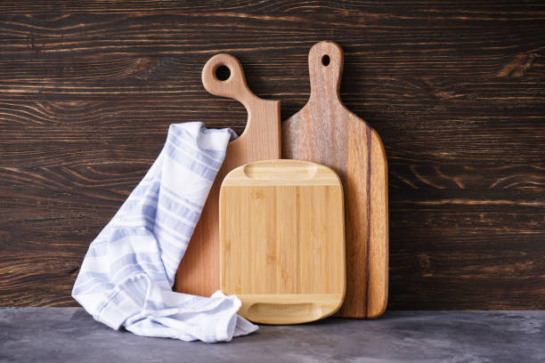 istock Cutting boards and kitchen towel on wooden background 1291493539
