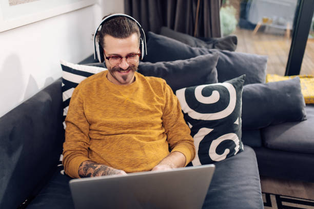 istock Happy freelancer enjoying on the sofa and working 1291495004