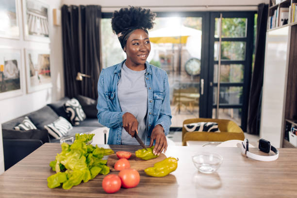 istock Young African American vegetarian cooking at home 1291495162