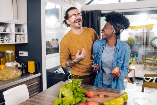 istock Happy multi-ethnic couple having fun while cooking their vegan dinner 1291495177