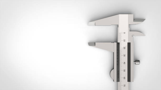 Slide calipers made of metal on a wooden table with rings. Jeweler's Tool