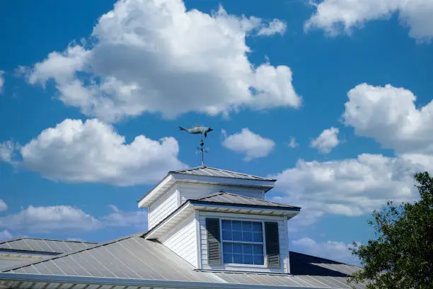 Roof Dormer with Wind Vane on Metal Roof