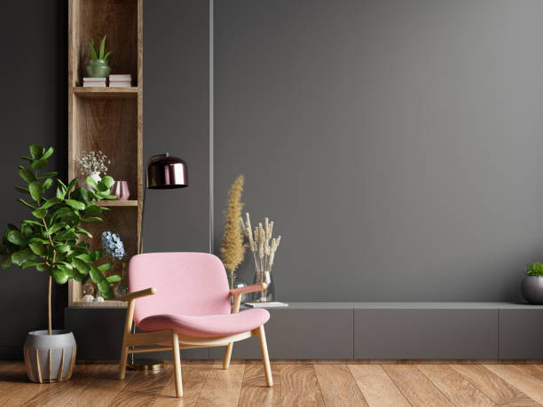 istock Colorful interior with a pink armchair on empty dark wall background. 1291504828