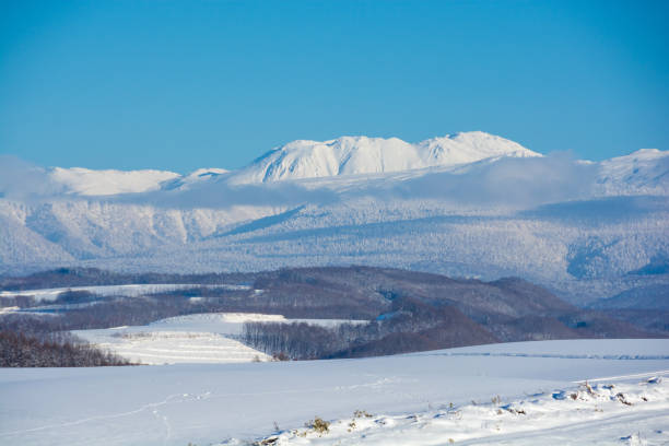 istock Snowy mountains and blue sky 1291505602