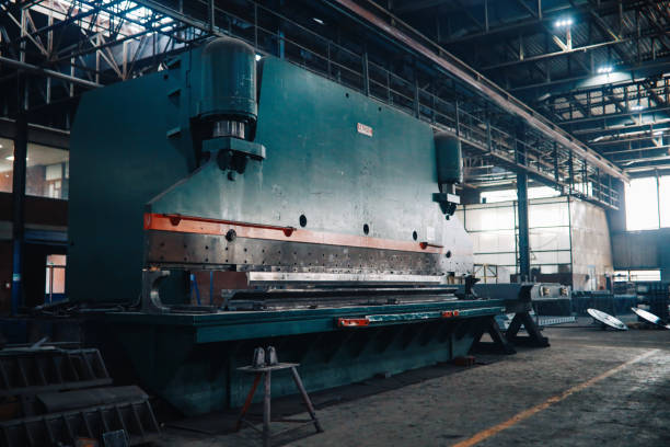 Large empty industrial space with factory machinery.