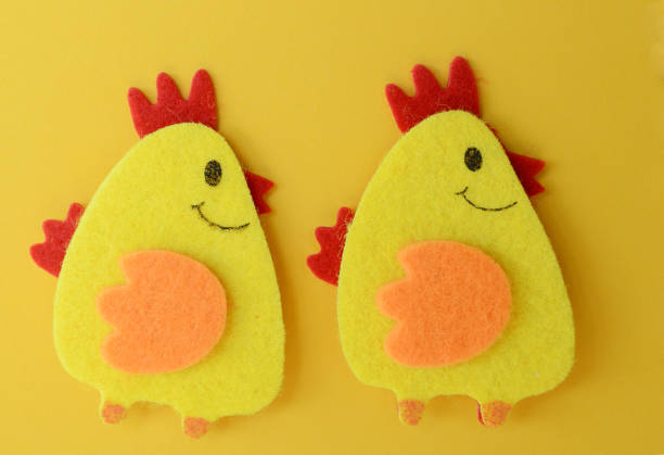 two cute yellow felt chickens handmade, diy, kids easter crafts, copy space, funny handmade idea stock photo
