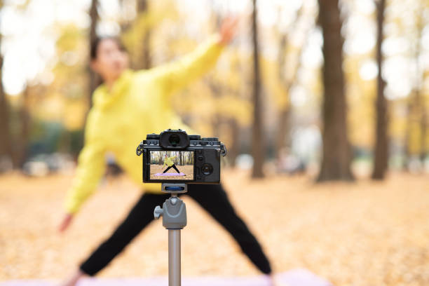 istock Youtuber teaching yoga in front of camera 1291507746
