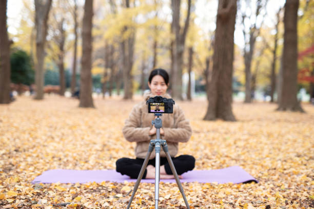 istock Youtuber teaching yoga in front of camera 1291507814
