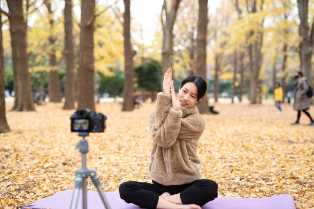 Youtuber teaching yoga in front of camera