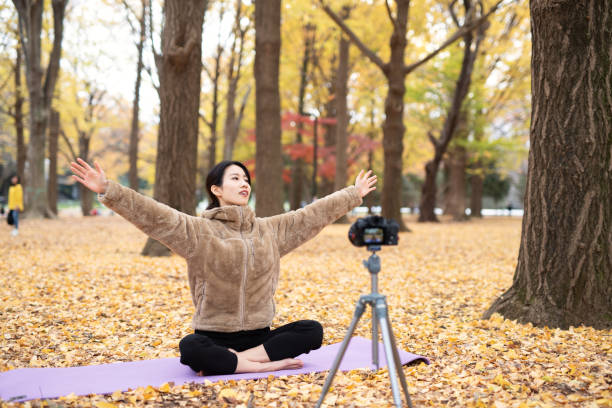 istock Youtuber teaching yoga in front of camera 1291507876