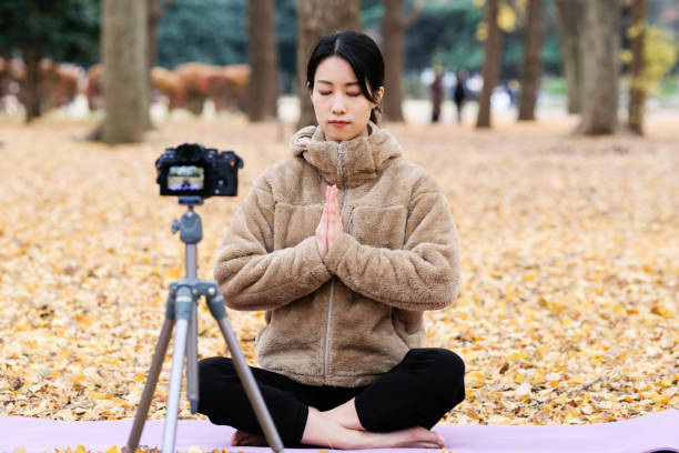 istock Youtuber teaching yoga in front of camera 1291507877