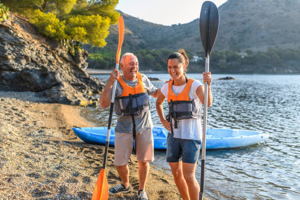 istock Lighthearted Spanish Kayakers Laughing on Beach 1291507909