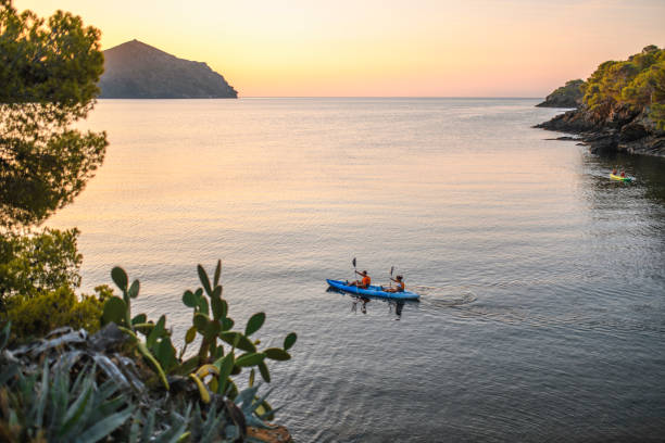 istock Kayakers Paddling Along Mediterranean Shore at Dawn 1291507944