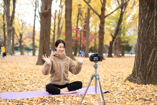 istock Youtuber teaching yoga in front of camera 1291508069