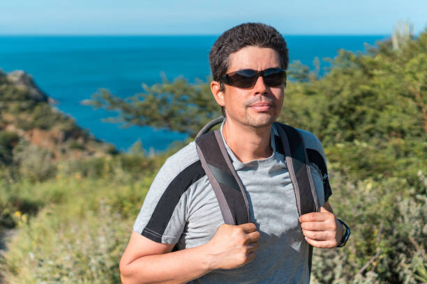 istock Man walking on the mountain looking at the camera 1291508694