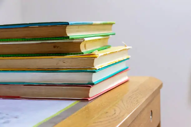 Photo of Books stacked on the desk